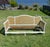 Likely Italian, in the French Provincial style settee featuring an elegantly carved wood frame with a graceful silhouette....