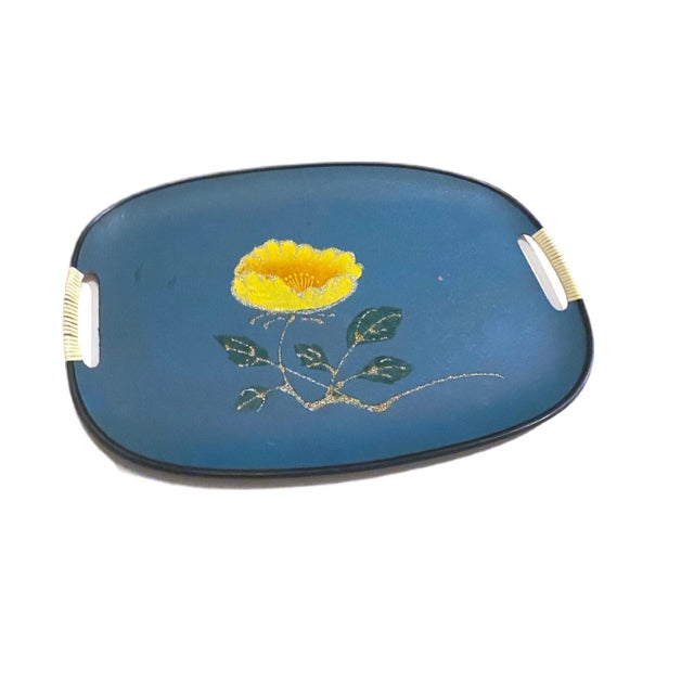 A funky turquoise tray with a yellow flower and a gold sparkly stem and sparkly green leaves. The front is in great...