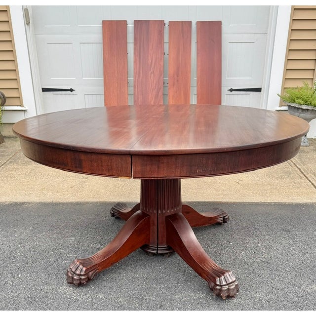 Good antique Victorian 54" round mahogany dining table with a split pedestal base with fluted pedestal and claw feet and...