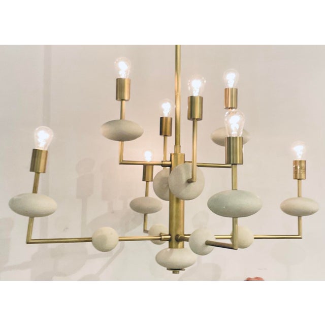 Original retail $2860, stylish Arteriors Modern Ricestone and Brass Vista Chandelier, showroom floor sample