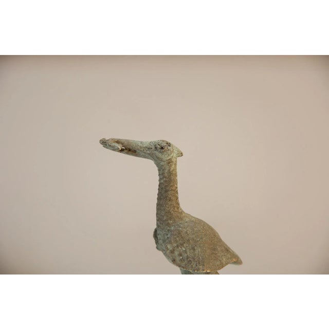 Vintage handmade African large oxidized bronze stork eating fish. Made approximately 40-70 years ago, each figure in this...