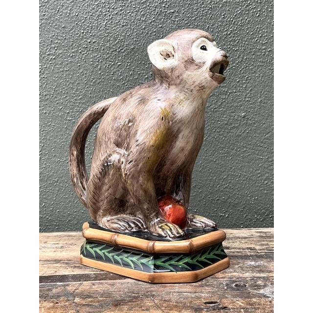 This charming vintage glazed ceramic monkey pitcher, designed by Raymond Waites for the "Safari" collection by Certified...