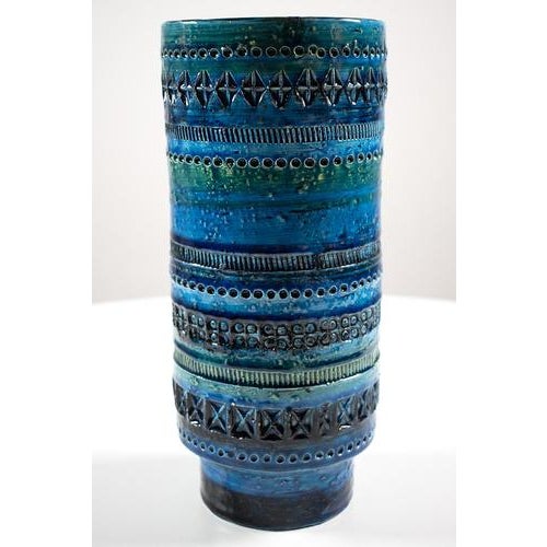 The Bitossi blue vase, produced in Italy, still looks fine. It has some very small chips, but is otherwise in good vintage...