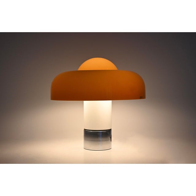 A plastic and metal lamp by Luigi Massoni, Brumbury model. Features a double switch to illuminate part or all of the lamp....