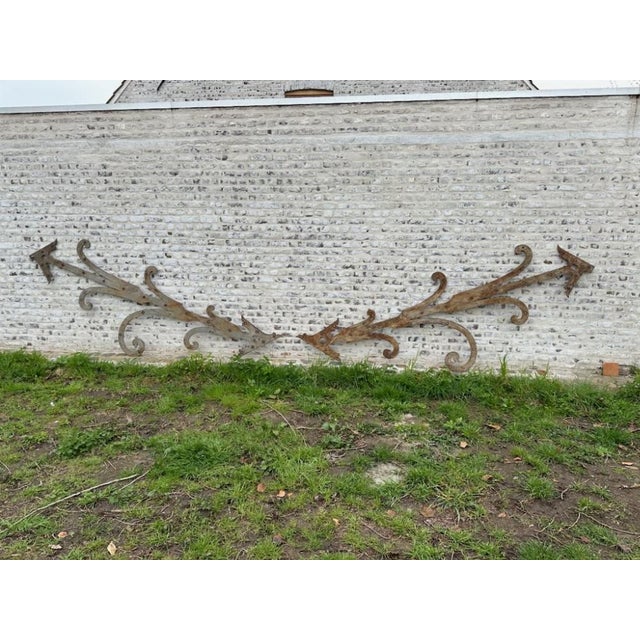 An extraordinary pair of giant French iron strap hinges, circa 1890, each measuring an impressive 115 inches in length....