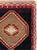 This Mid-20th century Turkish Anatolian gallery carpet presents a bold geometric composition arranged across a deep...