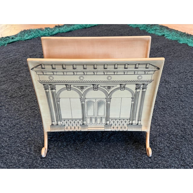 Inspired by the great Italian designer Piero Fornasetti, this magazine rack has been listed to be Italian in origin and...