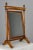 A 19th century French Empire Period cheval, or psyche mirror, crafted from solid walnut with a distinctive wood grain and...