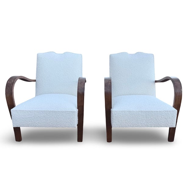 This striking pair of Art Deco lounge armchairs is executed in the style of Jindřich Halabala, the celebrated Czech...