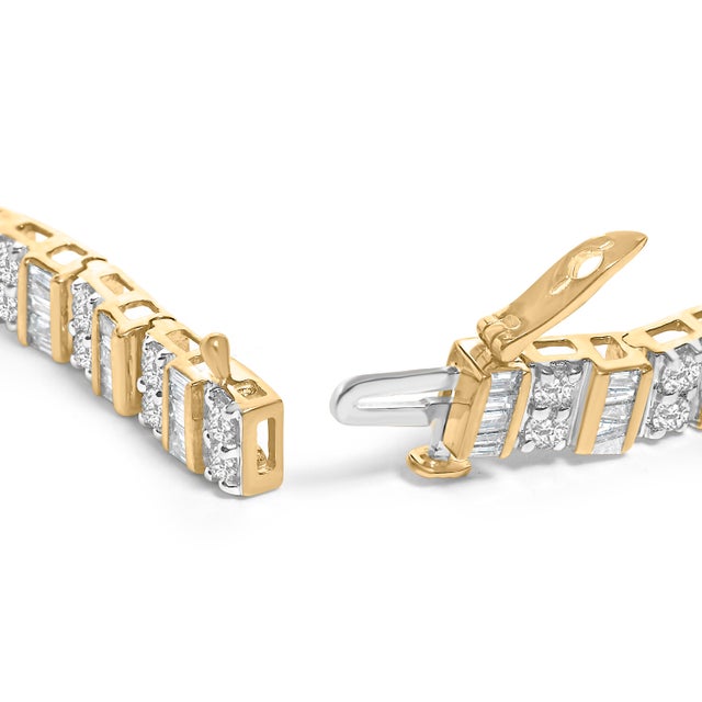 Both timeless and elegant, this 10Kt gold tennis bracelet features alternating bands of baguette and princess cut...