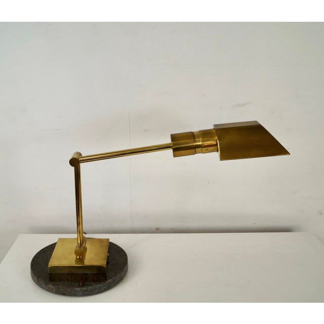Vintage 1970's Mid century Modern desk lamp for sale. It's made of solid brass, and it has a round marble base. It has a...