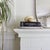 An onyx marble knot sculpture composed of two interlocking rings in soft tones of cream, peach, and taupe. The sculpture...