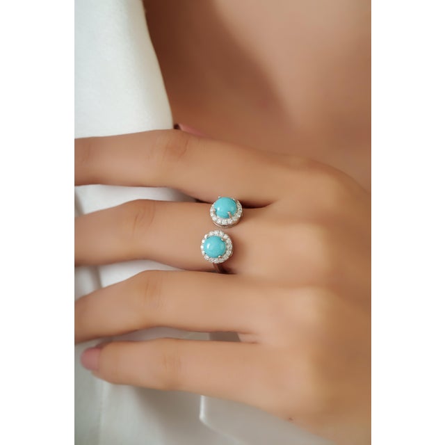 This modern open ring features 1.62 carats round turquoise set in 14K white gold. The turquoise measuring approximately 6...