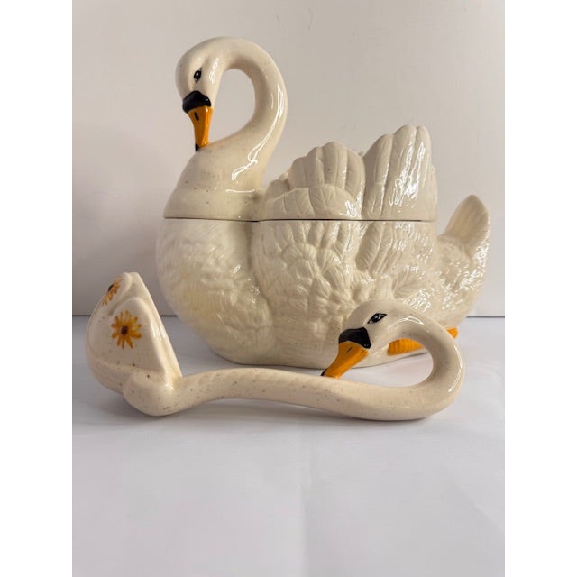 Elegant and charming, this vintage ceramic swan tureen brings a timeless cottage aesthetic to the table. Featuring a soft...