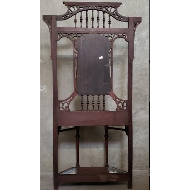 Striking antique hall tree in the late Victorian taste, featuring an unusually tall and airy architectural frame with...
