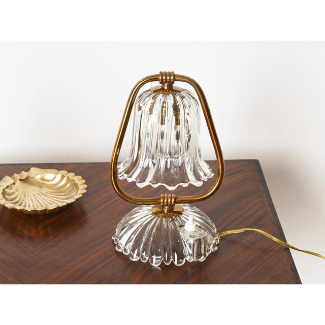 Gorgeous and unique pair of table lamps in murano mouth-blown crystal glass and solid brass. These romantic table lamps...
