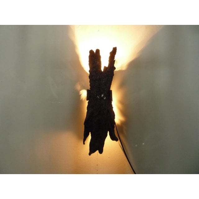 Extraordinary wall lamp made of iron. The lamp used to be in use in an old castle. It has 2 lamp sockets made of ceramic....