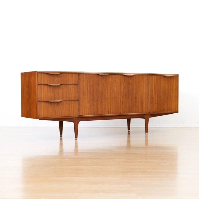 This vintage credenza was produced by McIntosh Furniture of Kirkcaldy Scotland during the 1960s. Produced in teak is a...