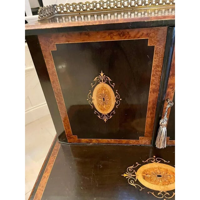 Unusual antique Victorian quality ebonised and burr walnut inlaid writing desk having an attractive original brass gallery...