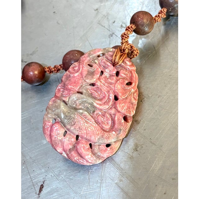 Carved pink rhodonite fish/buddha beaded pendant necklace w/ sterling silver metal clasp. Excellent condition.