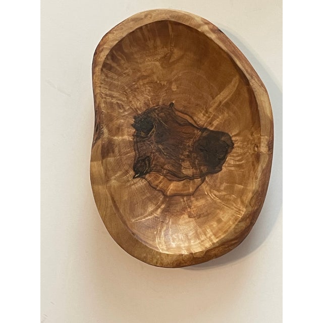 Two unique burl wood objects. An olive wood dish by ART D’OLIVE and a wormy elm wood bowl. The elm wood measures 5.5” x...