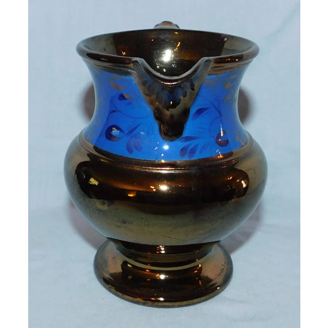 Sweet little antique copper lustreware creamer with cobalt band around neck