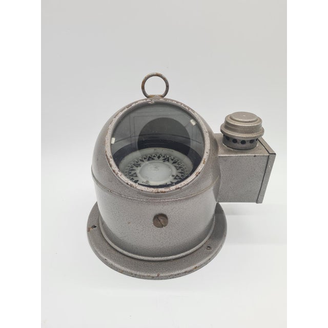 This marine compass from the 1960s represents the distinctive industrial design trend in navigation from the mid-20th...