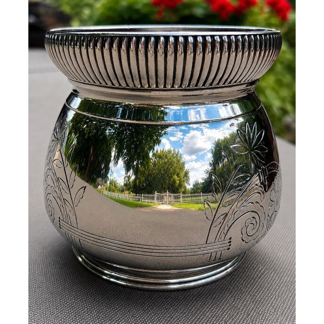 Grace your home with the timeless elegance of this exceptional antique Meriden Britannia Company silver-plated cachepot, a...
