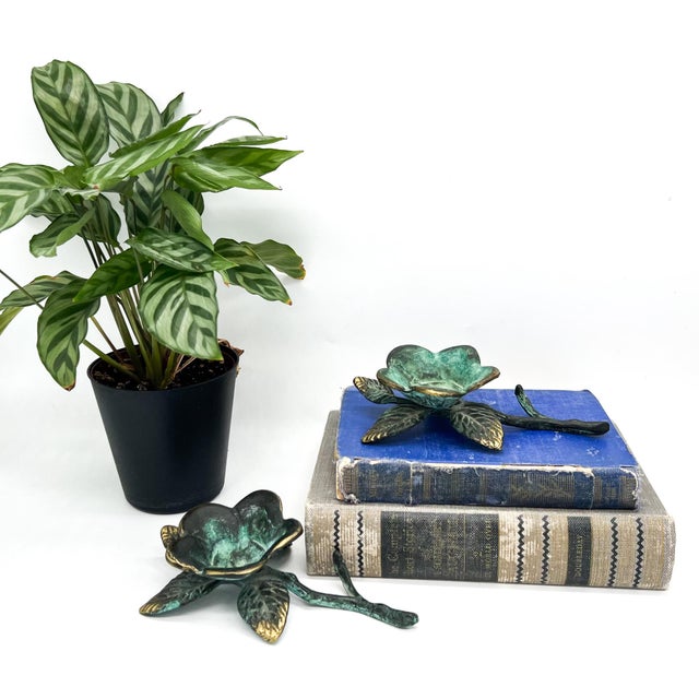 Beautiful pair of mid to late 20th century brass floral sculptural pieces with open flower forms, leafy detailing, and...