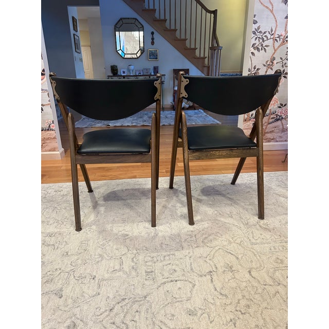 Midcentury Norquist Coronet Wonderfold folding chairs with walnut frames and black vinyl seats and backs. Attractive and...