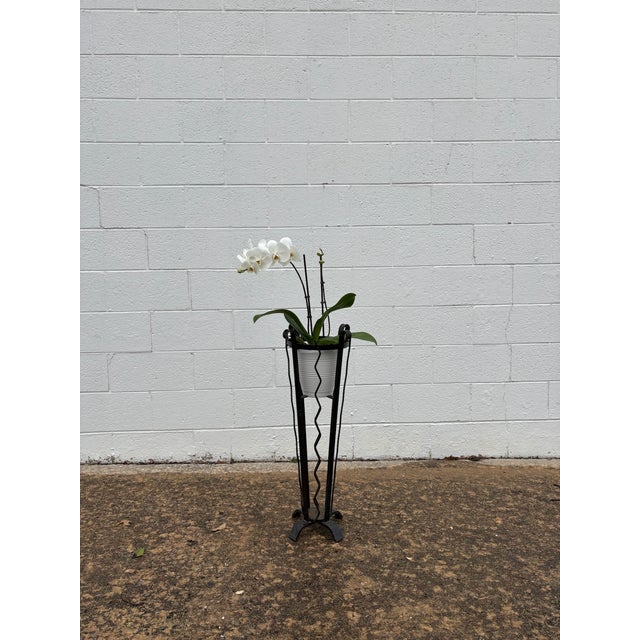 of tapering form, with wavy and straight vertical supports on a footed base, with inner supports for a potted plant....