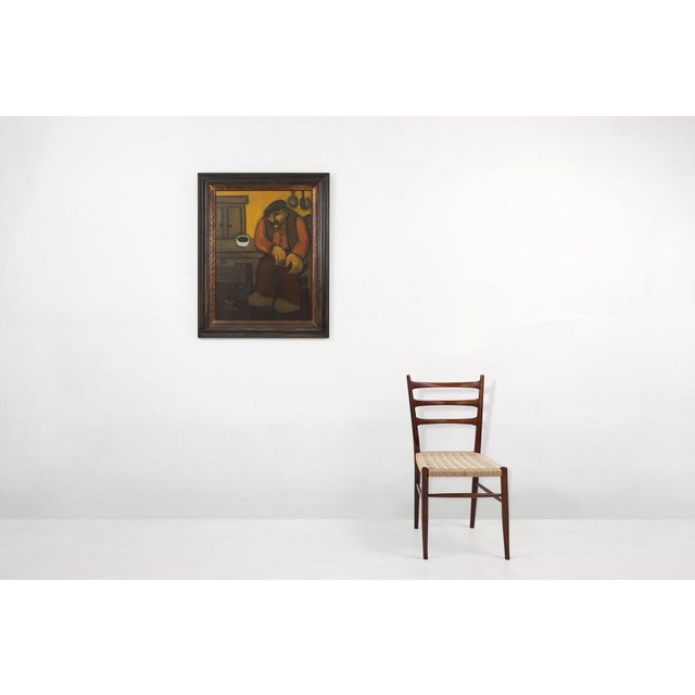 An oil painting of a solitary man seated at a rustic wooden table, exuding an air of contemplation and introspection....