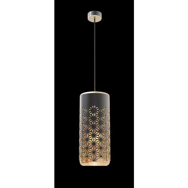 Antares suspension light in bronze and brass by aggiolight. Dimensions: d 15 x h 35 cm. Materials: dark antique bronze,...