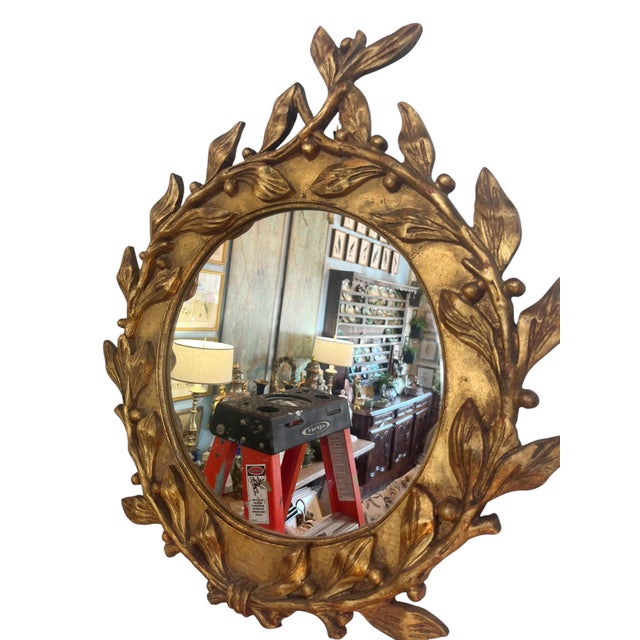A beautifully crafted 19th century French giltwood mirror featuring an elegant circular form encircled by a hand-carved...