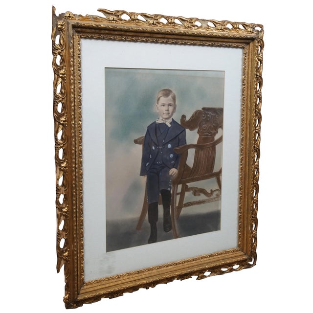Antique pastel portrait of a young boy in early 20th century clothing sitting upon a Victorian Northwind Chair. A sticker...