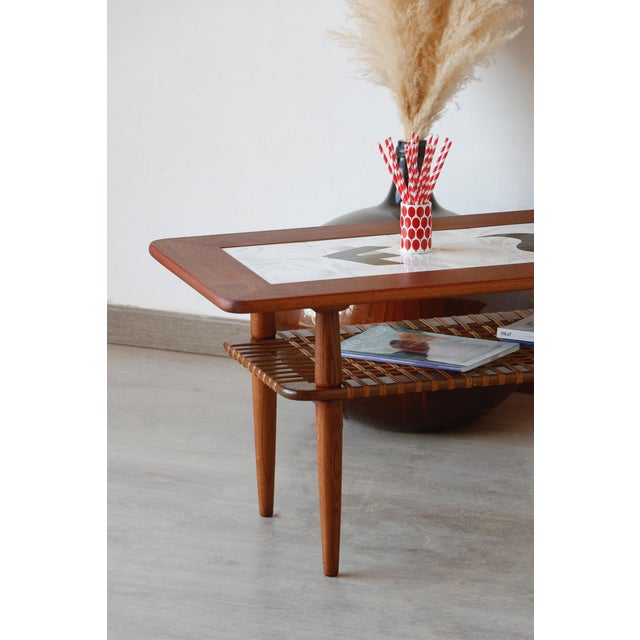 This vintage teak and ceramic coffee table perfectly embodies 1960s Scandinavian design. It was produced in Denmark by...