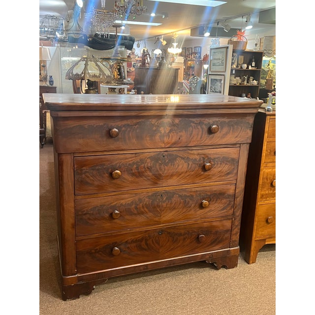 Beautiful mid to late 1800's flamed mahogany chest of drawers with unique rounded corner top drawer. This remains in good...