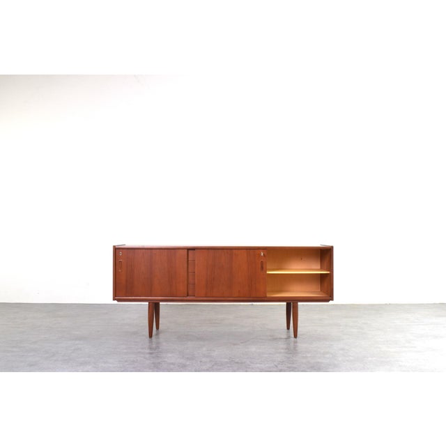 This beautiful sideboard exemplifies classic Danish design from the 1960s, whose primary goal was to combine simple form...