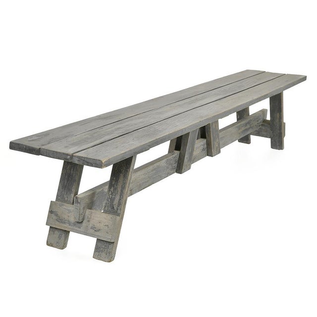 This antique solid wood bench seduces with its rustic line and its sober authenticity. Its gray-blue patina, resulting...