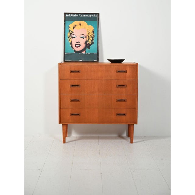 Scandinavian teak chest of drawers from the 1960s with four drawers and carved rectangular handles. Scandinavian teak...