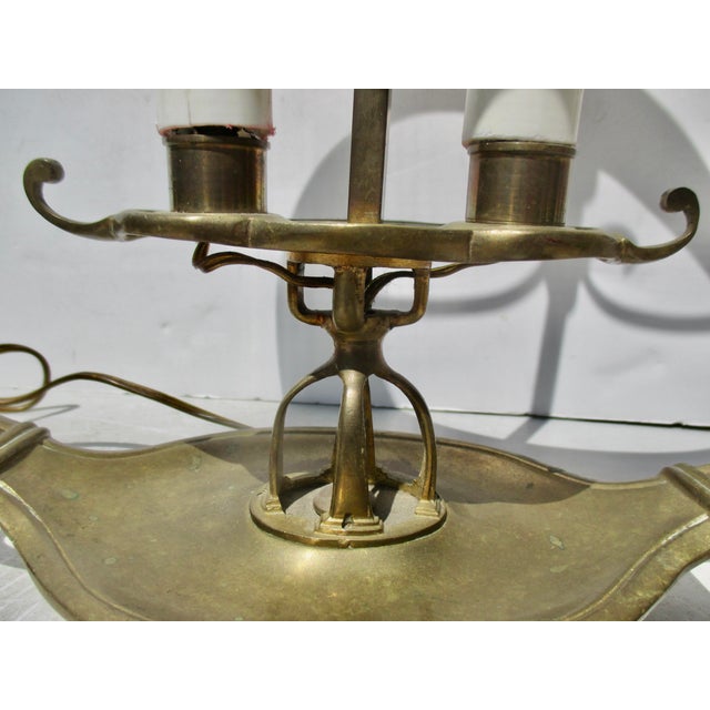 Early 20th-century Egyptian revival-style brass Bouillotte lamp. Deep red tole shade with a painted gold inner wall. The...