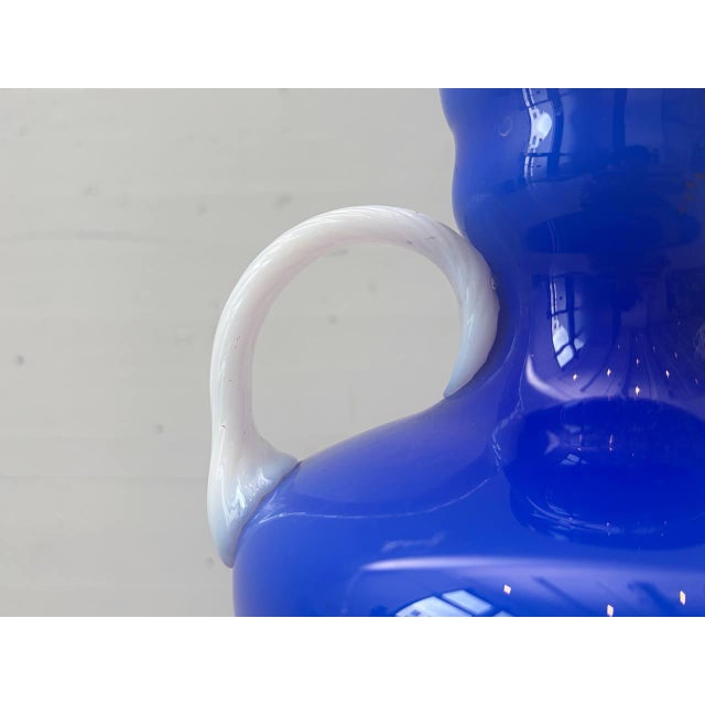 Decorative Italian opal glass vase from the Opalina Fiorentina manufactory, featuring a vibrant cobalt blue glass body and...