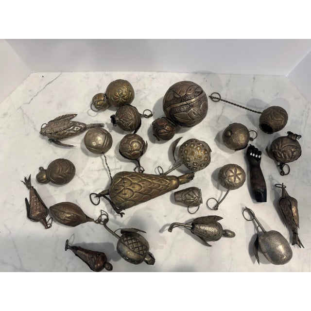 A collection of charming silver plate handmade Brazilian/African charms depicting fruits and various symbols. The charms,...