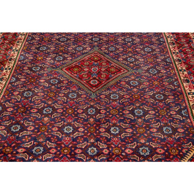 Beautiful vintage Persian Mahal hand-knotted wool rug with a red field. This piece has multicolor accents in an all-over...
