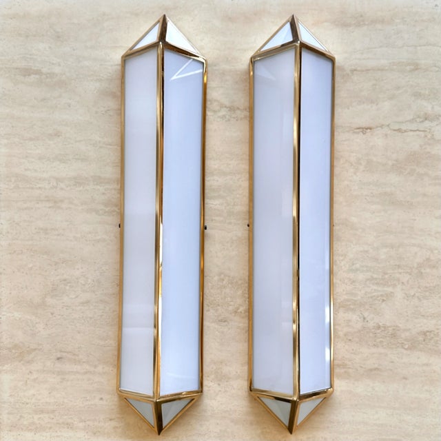 Wonderful Ralph Lauren style large milk glass and brass sconces. Elegance by definition. The mix of milk glass and brass...