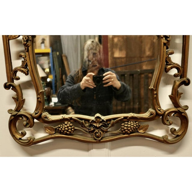 Elaborate Atsonea Rococo Gilt Wall Mirror The Mirror is decorated in the Rococo style with a Wide Pierced Gilt Frame, it...