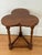 A fine English cricket table of oak featuring a clover top over a tripod base with triangular brace. A charming occasional...