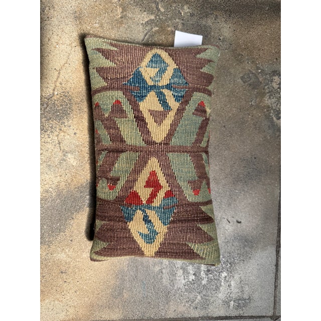 Embrace the charm of nomadic artistry with this 19th Century Ghashghai Kilim pillow, a handwoven masterpiece rich in...