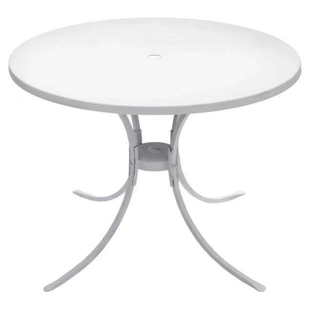 Round patio table with umbrella hole/holder. New paint in clear clean white. Chairs are available on separate listing.