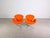 Two beautiful Swan chairs in a modern orange color by Fritz Hansen. This design, now considered an absolute classic, is by...